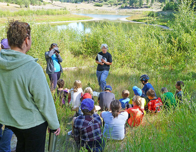 NNS amphibian project coordinator talks to the children at Kentucky-Alleyne park with the Western Toad breeding pond (West Pond) behind. Photo:  Alan Burger